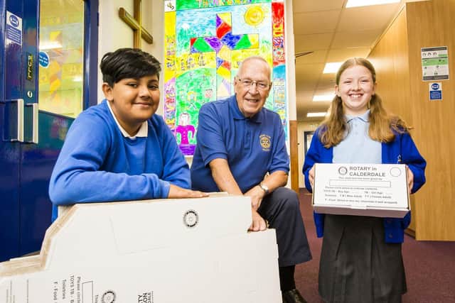 Launching the Calderdale Rotary Clubs' Christmas Shoebox Appeal is co-ordinator Byran Harkness  at Christ Church CE Primary School with pupils Auwj Hussain, 10,  and Violet Robinson, 11.