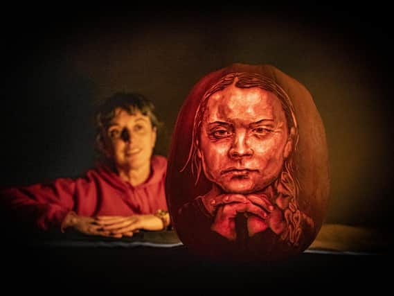Liz warrington pumpkin carver at Sand in your Eye looks at the portrait of Greta Thunberg by the company. Picture Tony Johnson