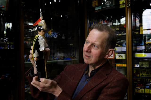 Simon  Haley the owner of  the Collectors Old Toy Shop in Halifax. with a Palitoy Action Man  dressed as a Lancer        c 1970's