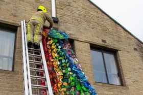Firefighters install the waterfall at Illingworth Moor Methodist Church. Photo by The Flat Cap Photographer.