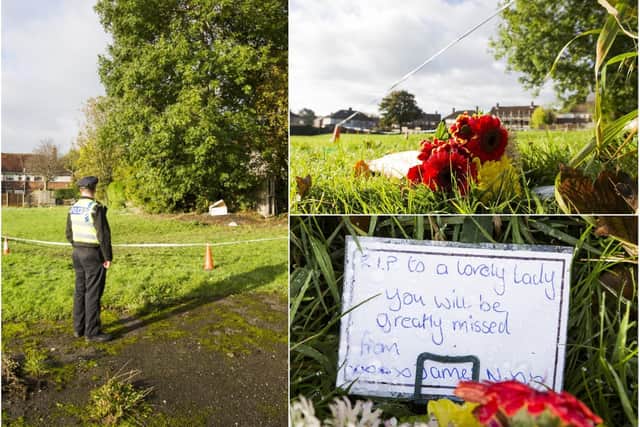 Flowers have been left at the scene where a woman's body was found