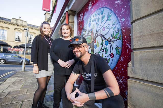 Tami Sykes, Christine Gow and Torban Aspinall at Harvey's of Halifax with their 12 days of Christmas-themed window, part of a trail taking place across the town.