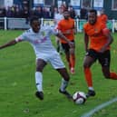 Brighouse Town goalscorer Laurence Sorhaindo takes on Tadcaster defender Kesi Omolokun. Pic: Steve Ambler