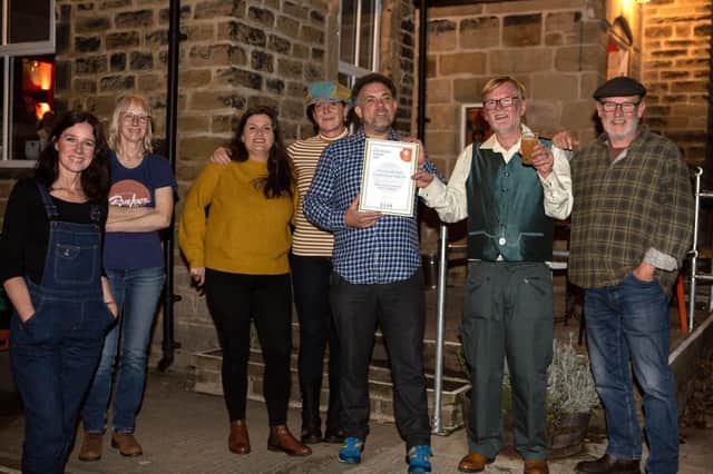 The team from The Puzzle Hall Community Pub with their award