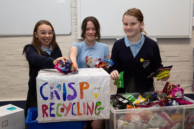 Lee Mount Primary School pupils Ellie Patrice, Imogen Doran and Darcey Lowther with some of the packets they have collected for recycling.