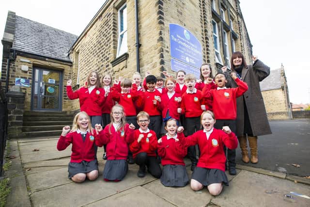 Greetland Academy pupils with Principal Helen Crowther celebrating their 'Outstanding' Ofsted report.