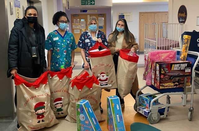 Some of the Bluefin team present the gifts to Calderdale Royal Hospital's children's ward.