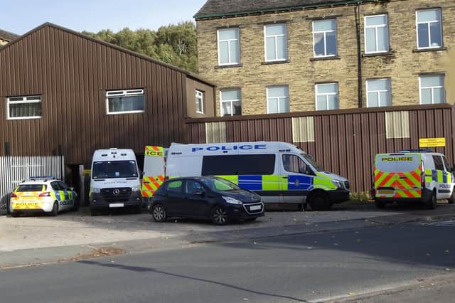 Police vehicles at the scene of the raid. Photo by Stuart Black.