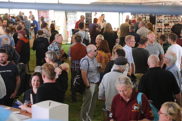 Peterborough Beer Festival 2019 at the Embankment.  Visitors enjoying a glass EMN-190820-175846009