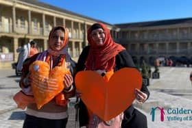 People with orange hearts which is the symbol showing that Calderdale is a Valley of Sanctuary and a safe place for refugees.