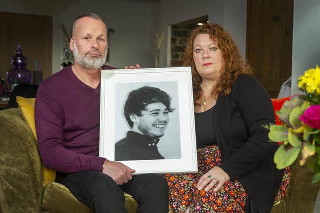 Andrew and Joanne Doody with a portrait of their son Peter
