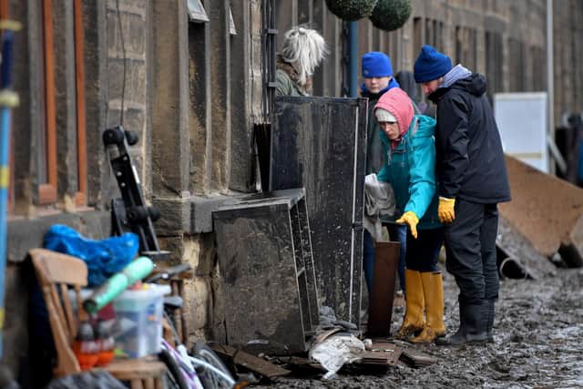 Mytholmroyd residents begin clearing up following severe flooding beside the River Calder after the deluge brought about by storms in February 2020. Photo by Anthony Devlin/Getty Images
