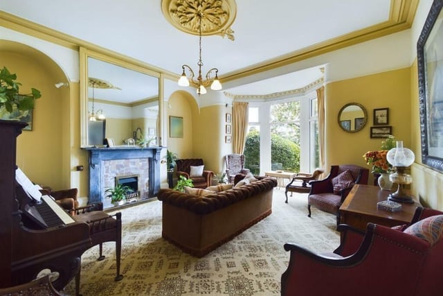 The bay-fronted lounge with its decorative ceiling rose, and marble and Cornish slate fireplace.