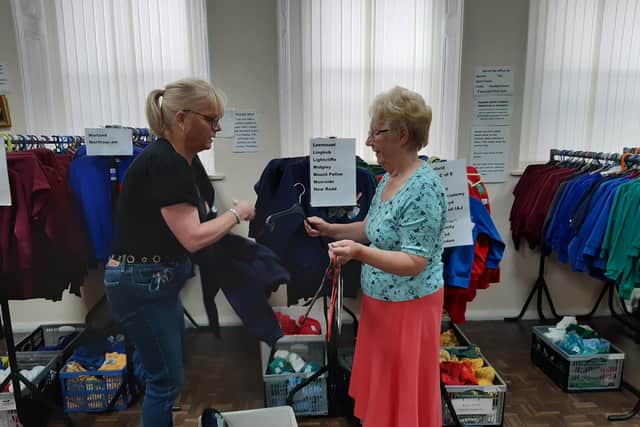 Debbie Pearson and Carol Green sort items at Halifax YMCA's school uniform exchange