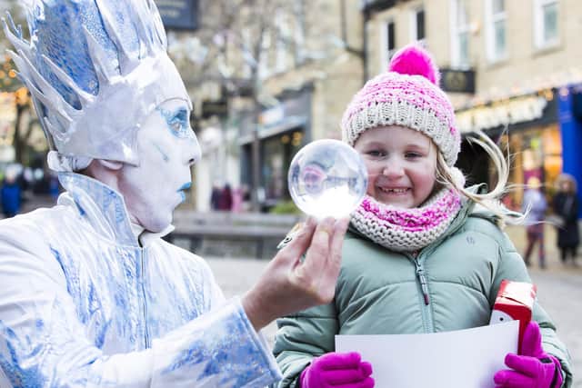 Ellie Dix, six, with The Icicle King and his magic ball at The Woolshops at a previous town centre Christmas event