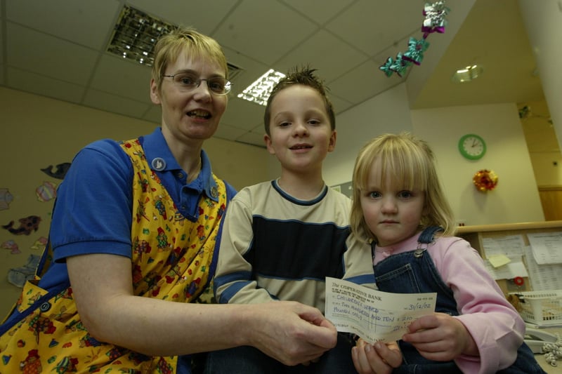 Seven-year-old Matthew Leedham who raised £210 from a sponsored walk round the Shay, is pictured with his sister, Bethany, 3, presenting the cheque to senior ward sister Brenda Barth