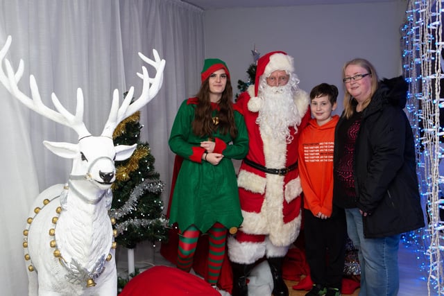 Joshua Poole and Diane Crompton, with Santa and his helper at Light Up the Valley, Mytholmroyd Community Centre