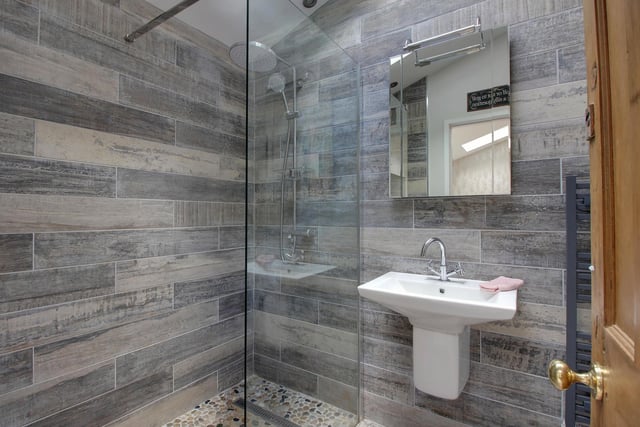 A walk in shower within the modern suite in this contemporary style shower room.