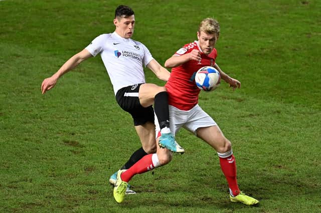 LONDON, ENGLAND - FEBRUARY 02: Jayden Stockley of Charlton Athletic and James Bolton of Portsmouth compete for the ball during the Sky Bet League One match between Charlton Athletic and Portsmouth at The Valley on February 02, 2021 in London, England. Sporting stadiums around the UK remain under strict restrictions due to the Coronavirus Pandemic as Government social distancing laws prohibit fans inside venues resulting in games being played behind closed doors. (Photo by Justin Setterfield/Getty Images)