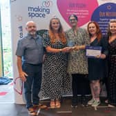 Carers Wellbeing Service Calderdale collecting its award from charity Making Space