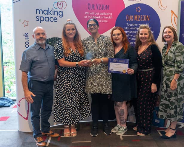 Carers Wellbeing Service Calderdale collecting its award from charity Making Space