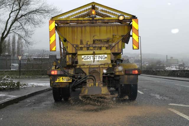 A gritter spreads salt on the district's roads ready for winter and icy weather snow conditions.