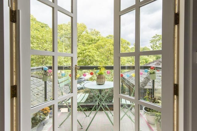 A balcony with country views is accessible from the apartment kitchen.