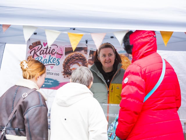 Katie with customers at her stall Katie Bakes