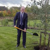 Ed Anderson, Lord-Lieutenant of West Yorkshire planting the tree in the garden of Huddersfield's Forget Me Not Children’s Hospice.
