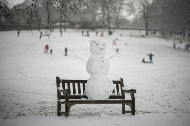 A snowman takes in the wintry view from a bench in Shibden Hall Park