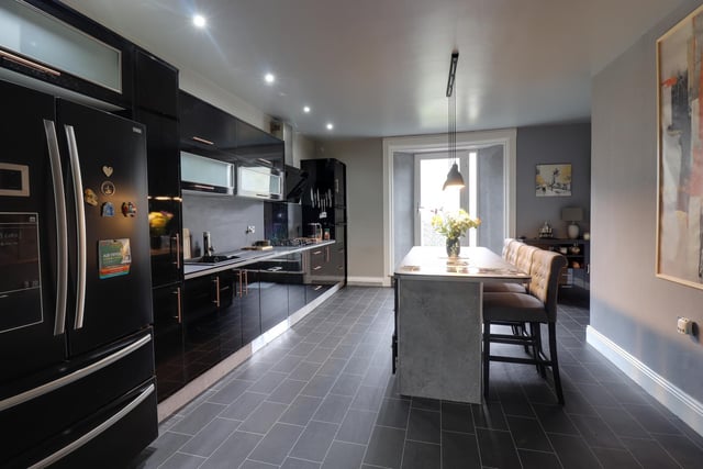 An alternative view of the kitchen, that has a walk-in larder and utility room as added facilities.