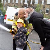 Firefighter James Barker with Marshall -Marley Hanson at Halifax Fire Station open day