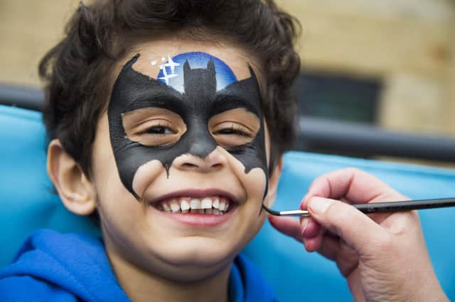 Mohsin Sadiq, four, gets his face painted.