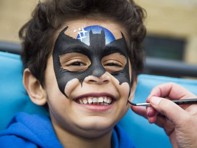Mohsin Sadiq, four, gets his face painted.
