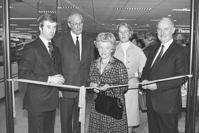 Gwenda Ackroyd, centre, cutting the ribbon to open the Boots shop in Halifax, with Keith Ackroyd on the right