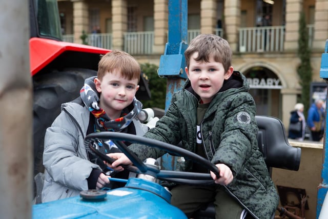 Cousins Trevor Cain and Chester Wells at tractors and farm vehicles in the courtyard at The Piece Hall, Halifax