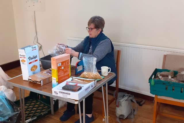A volunteer helping at a community food bank run by Christians Together Calderdale