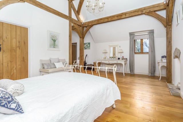 A spacious double bedroom with exposed beams.