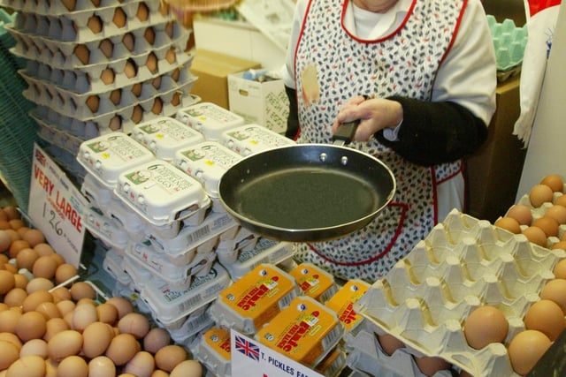 Shirley Asquith, Manager of Pickles Farms Ltd in the Halifax Market, flipping pancakes for Pancake Day in 2005