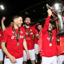 WREXHAM, WALES - APRIL 22: Elliot Lee of Wrexham celebrates with the Vanarama National League trophy as Wrexham win the Vanarama National League and are promoted to the English Football League after victory in the Vanarama National League match between Wrexham and Boreham Wood at Racecourse Ground on April 22, 2023 in Wrexham, Wales. (Photo by Jan Kruger/Getty Images)