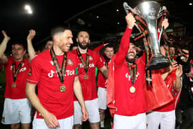 WREXHAM, WALES - APRIL 22: Elliot Lee of Wrexham celebrates with the Vanarama National League trophy as Wrexham win the Vanarama National League and are promoted to the English Football League after victory in the Vanarama National League match between Wrexham and Boreham Wood at Racecourse Ground on April 22, 2023 in Wrexham, Wales. (Photo by Jan Kruger/Getty Images)