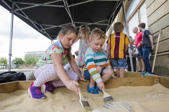 Eadie Smith, seven, and Ted Smith, three, dig for dinosaur bones.