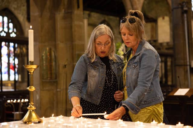 Visitors light candles at Halifax Minster for the Queen after her passing in September.