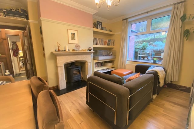 There's a stylish living and dining room, with a multi-fuel stove within the fireplace.