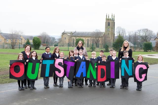 Staff and pupils at St. Andrew's CE Junior School in Brighouse celebrate their 'Outstanding' Ofsted report.