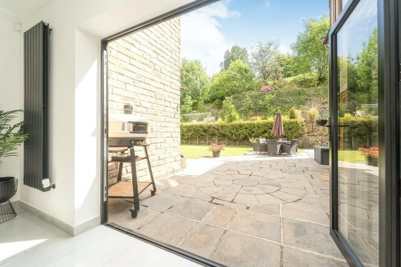 Two sets of bifold doors invite the beauty of the outdoors in.