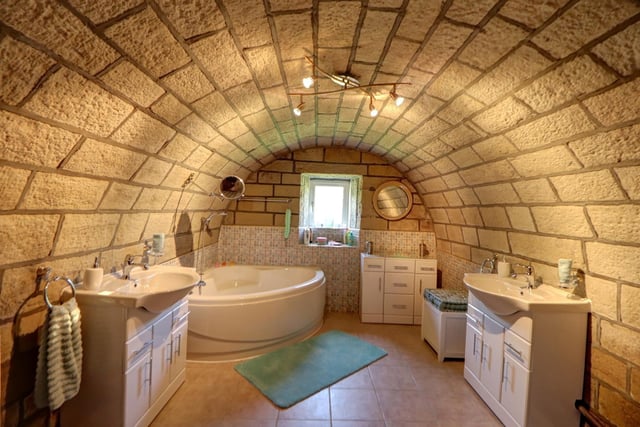 Ground floor bathroom with stunning curved stone ceiling.