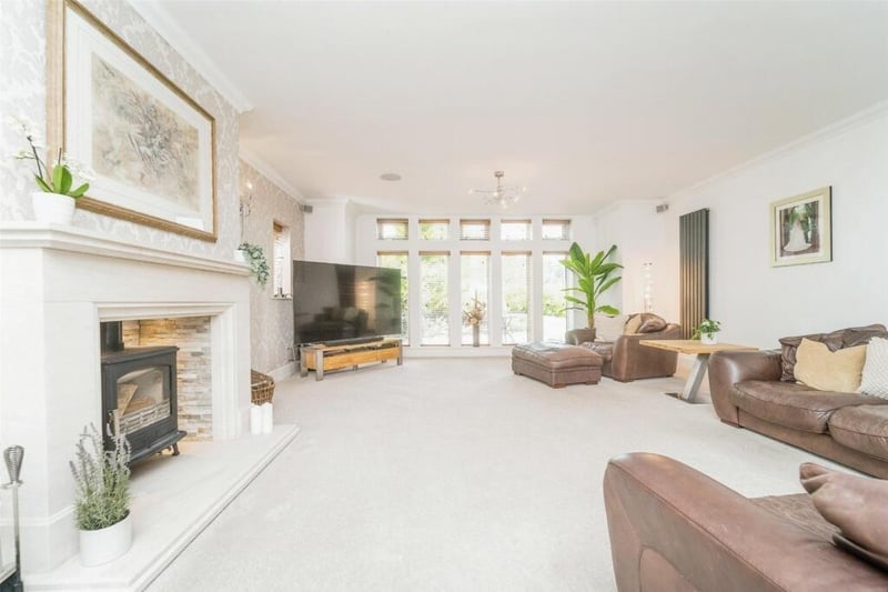 A bright and spacious reception room with feature fireplace.