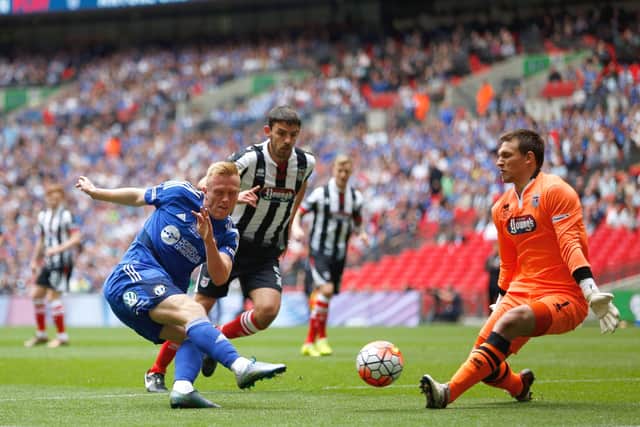 LONDON, ENGLAND - MAY 22:  Jordan Burrow of FC Halifax Town fires a shot at James McKeown of Grimsby Town during the FA Trophy Final match between Grimsby Town FC v FC Halifax Town at Wembley Stadium on May 22, 2016 in London, England.  (Photo by Joel Ford/Getty Images)