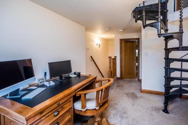 The first floor landing doubles as an office or study area, and has a spiral staircase up to the main bedroom suite.